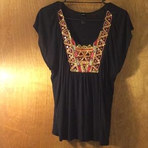 H&M black top with sequin detail around neckline.